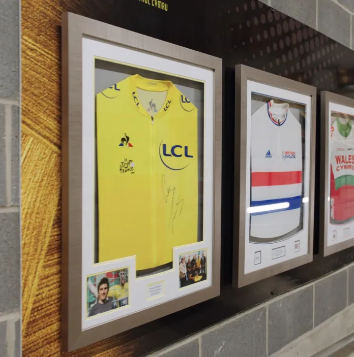 Wall of cycling jersey's at a velodrome.