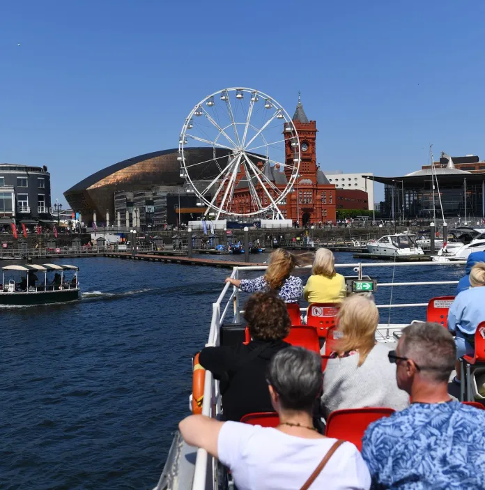 People of a boat trip heading towards the bay's attractions.