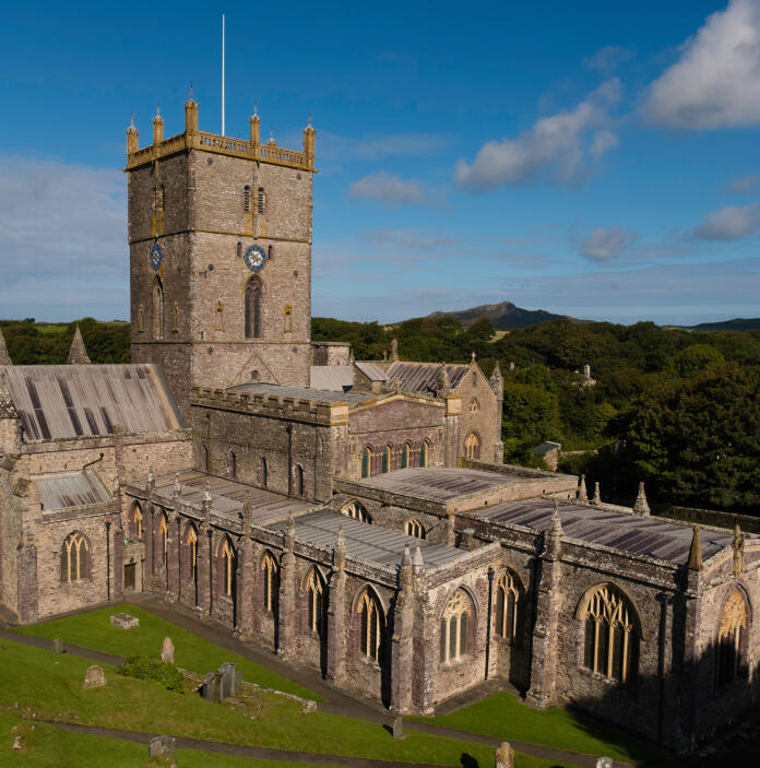 Image of St Davids Cathedral with grass in the foreground and blue skies in the background