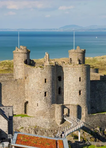 Aerial view of a castle with the sea and golf course beyond, 