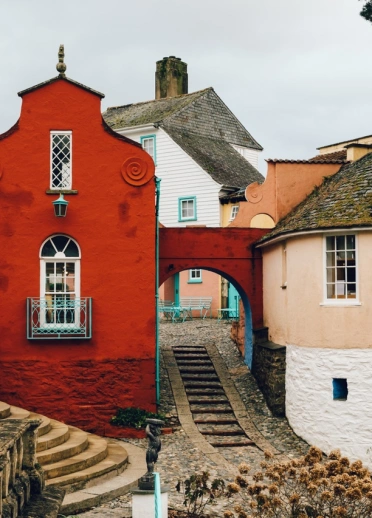 Colourful houses and stone paths and steps in an ornate village.