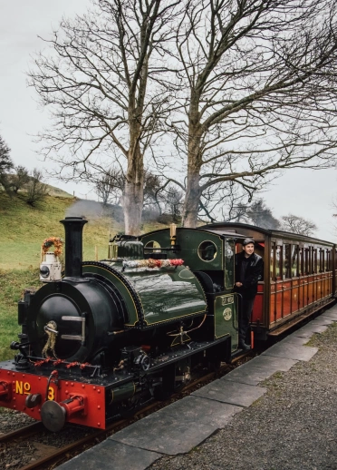 A steam train at a station.