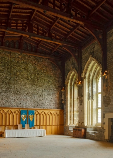 Inside a banqueting hall in a castle.