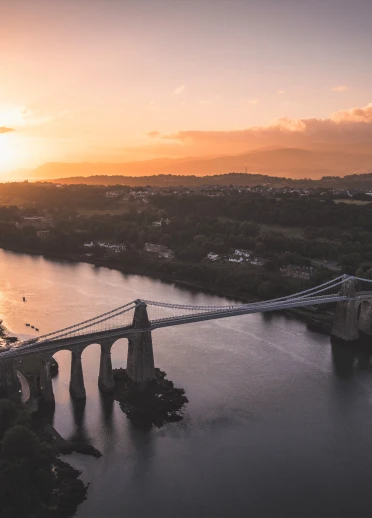 Aerial view of Menai Suspension Bridge in the sunrise.