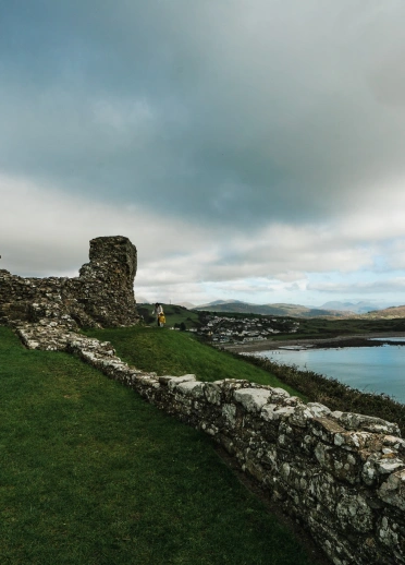 View of the coast from the ruins of a castle on a hill.