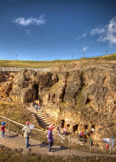 A group of people exploring the entrance to the Great Orme Mines.