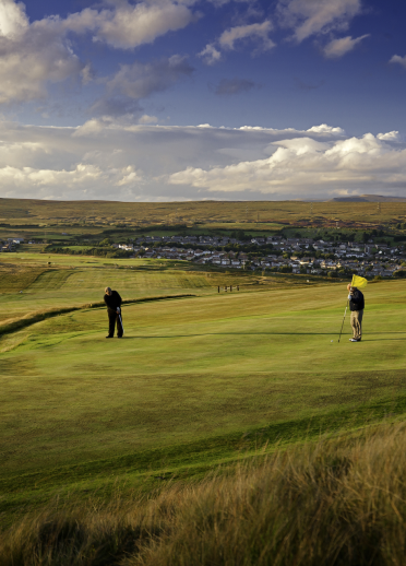 Golfers putting on the green at West Monmouthshire Golf Club.