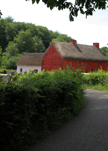 A hedged path leading to cottages at St Fagans National Museum of History.