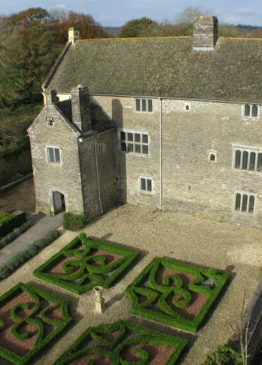 View from above of Llancaiach Fawr manor house and gardens with decorative hedges.