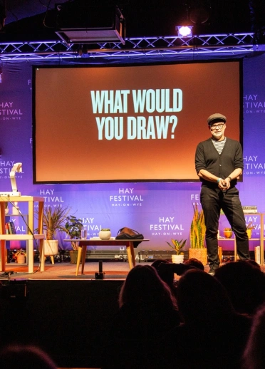 A man on stage at a literature festival.