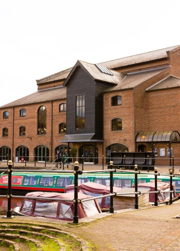 A theatre next to a canal.
