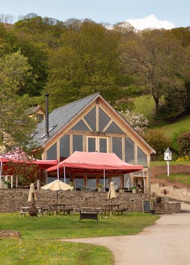 A vineyard visitor centre with seats to eat and drink outside.