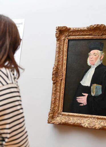 A woman looking at a portrait
