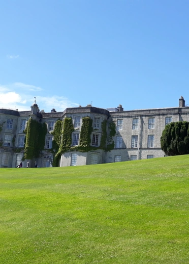 A grand house on imaculate lawns.
