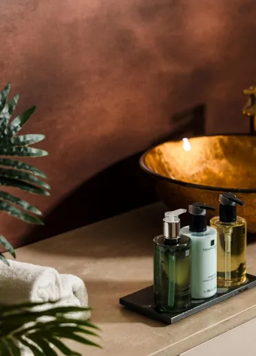 Basin, towels and toiletries on display in a spa.