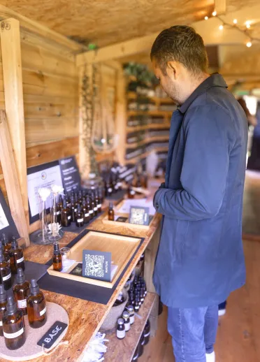 Group of people in a wooden hut creating perfumes in a workshop.