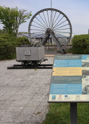 A miner's winding wheel and information board.