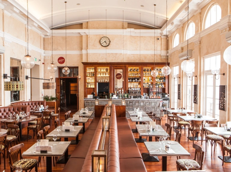 inside view of a restaurant with tables and chairs and the bar.