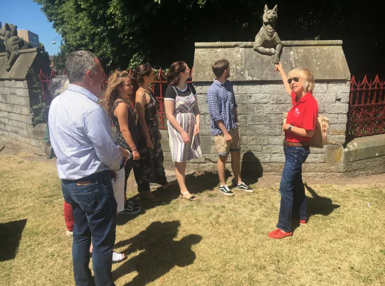 A group of people on a Loving Welsh Food tour by the Animal Wall, Cardiff Castle.