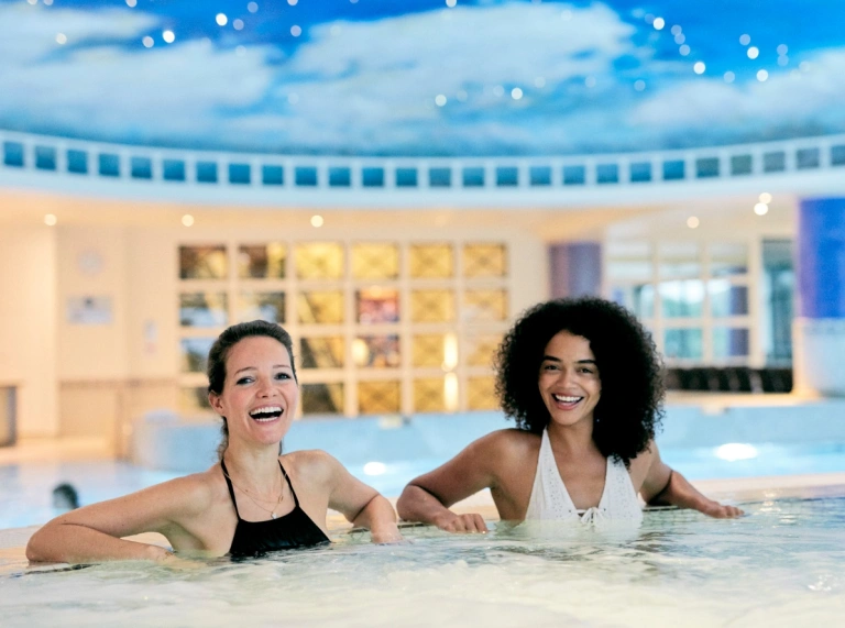 A couple of ladies enjoying the spa in a luxury hotel.