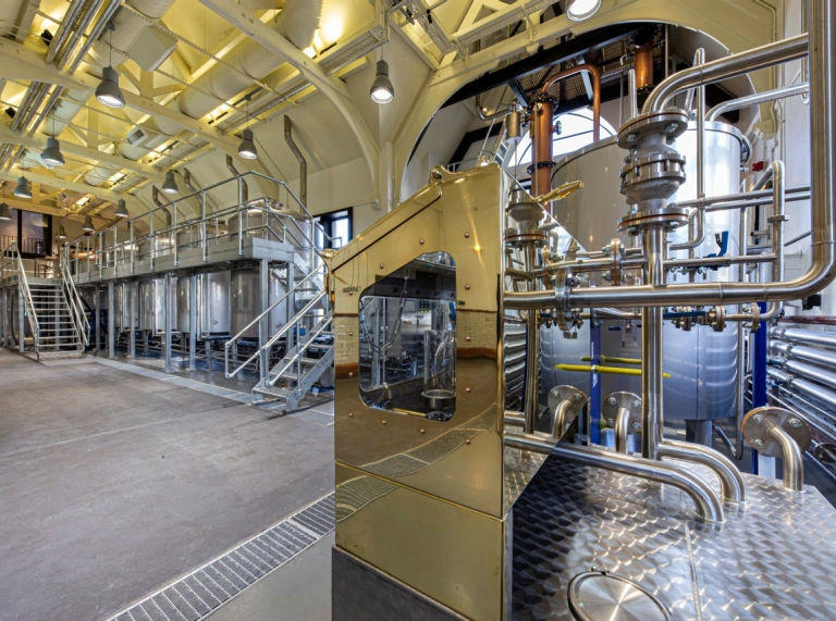 A room with a vat and distilling equipment.