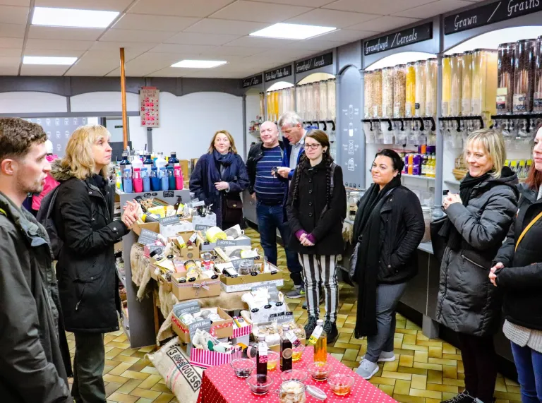 Group of people enjoying the Green Food Tour by Loving Welsh Food at Iechyd Da, Whitchurch.