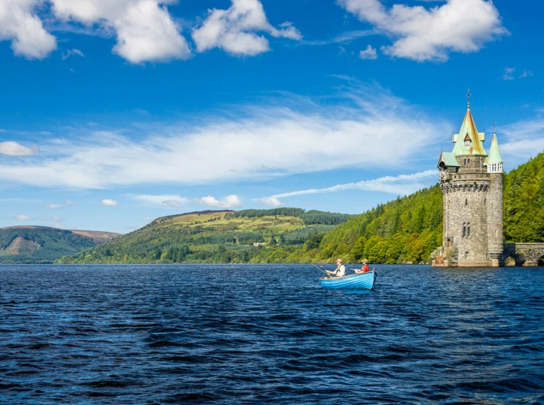 A boat on a lake with a turret.