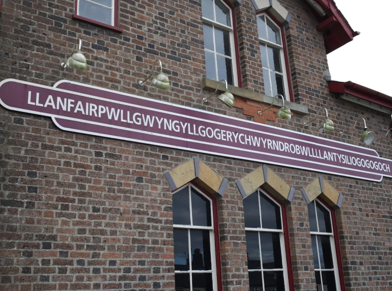 A sign on a railway station which shows off the 58 character longest name.