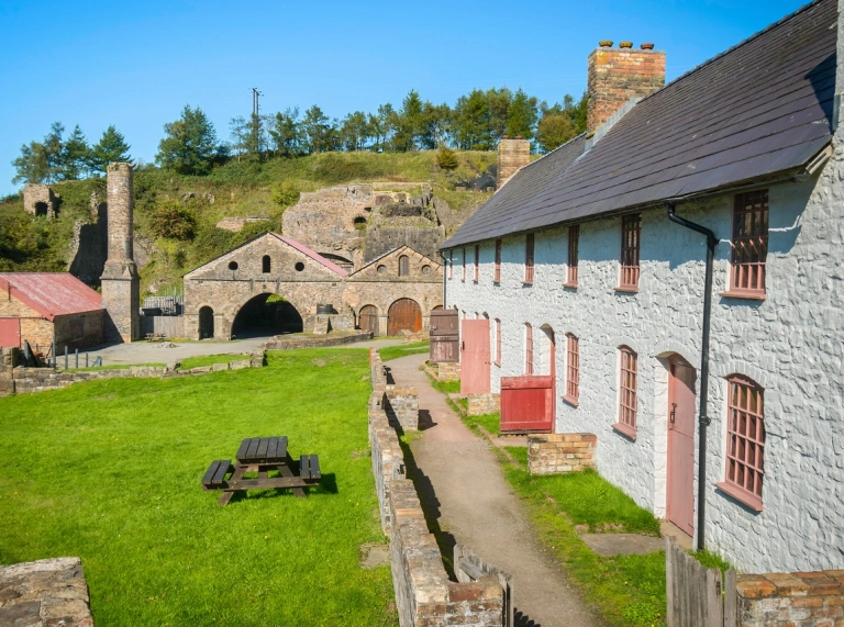 Ironworks and row of white-washed cottages.