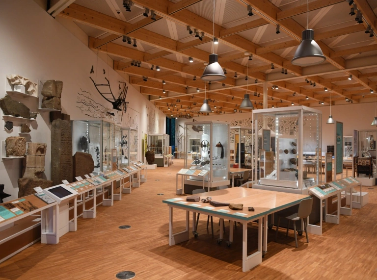 Relics on display in glass cabinets at a newly built wing of a museum.