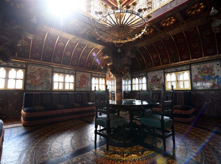 Sunlight streaming through one of the grand opulent rooms featuring a chandelier at Cardiff Castle.