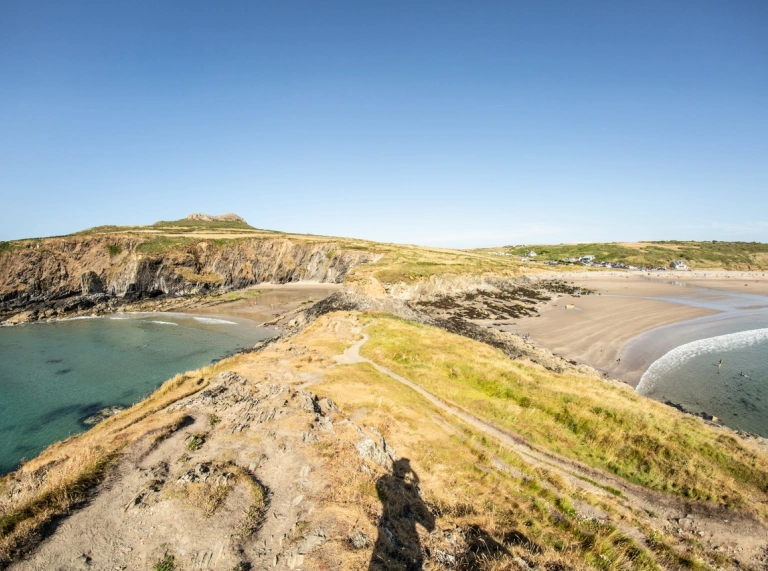 A view of a headland on a coast path with the ocean either side.