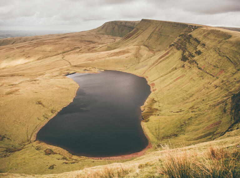Llyn y Fan Fach from above with cloudy skies.
