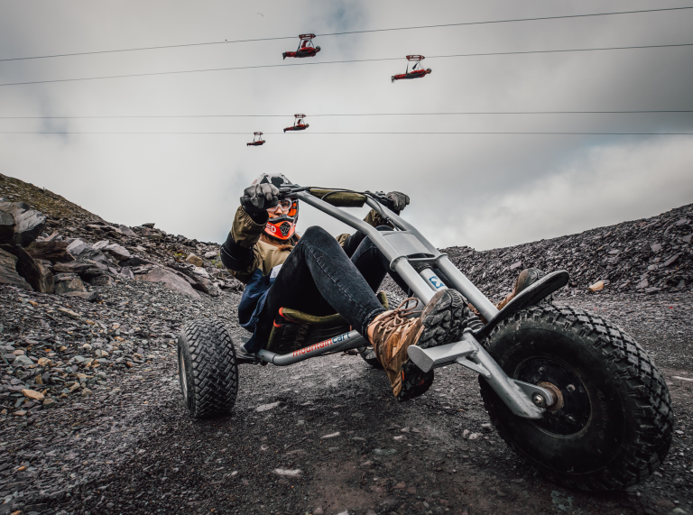 Quarry Kart at Zip World with people on the zip line above