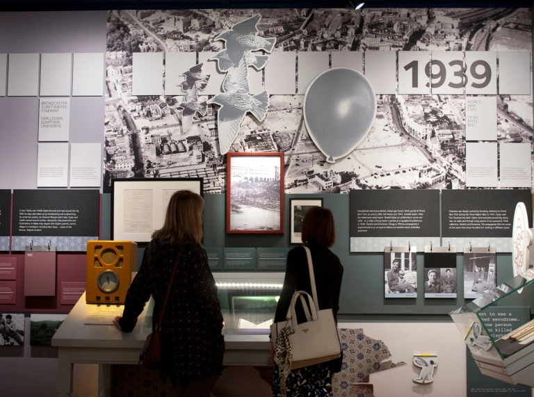 two females looking at display in museum.