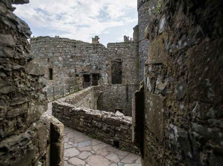 Stone walls and paths inside Harlech Castle.