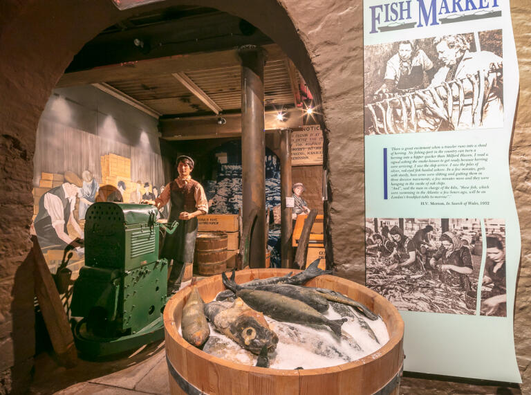 Displayed models and props in a museum depicting an old fish market.