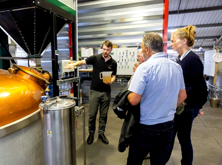 A group on tour at a whisky distillery.