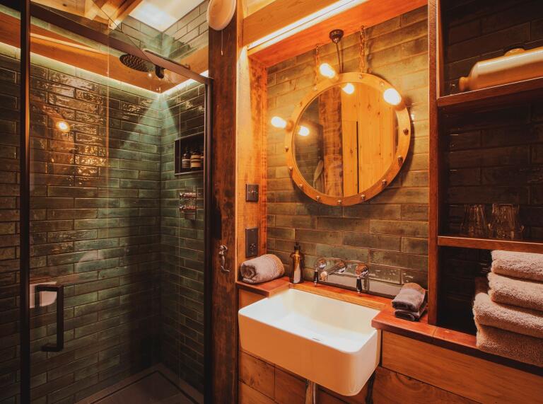 A luxury shower room with wood and tiled panelling.