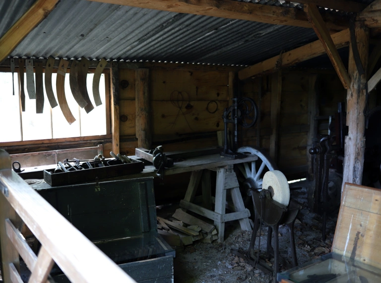 A workshed with tools and workbenches at a museum.