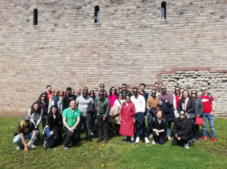 A group of people outside a castle.
