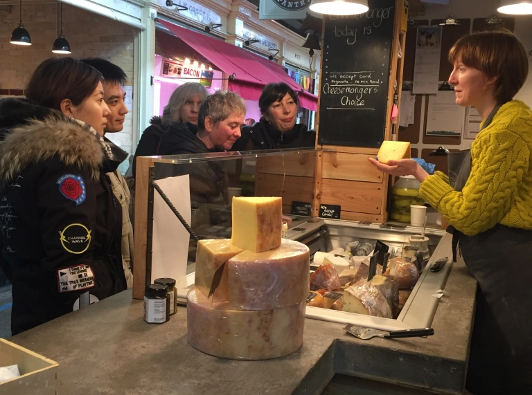 A group of people taking a food tour in a market.