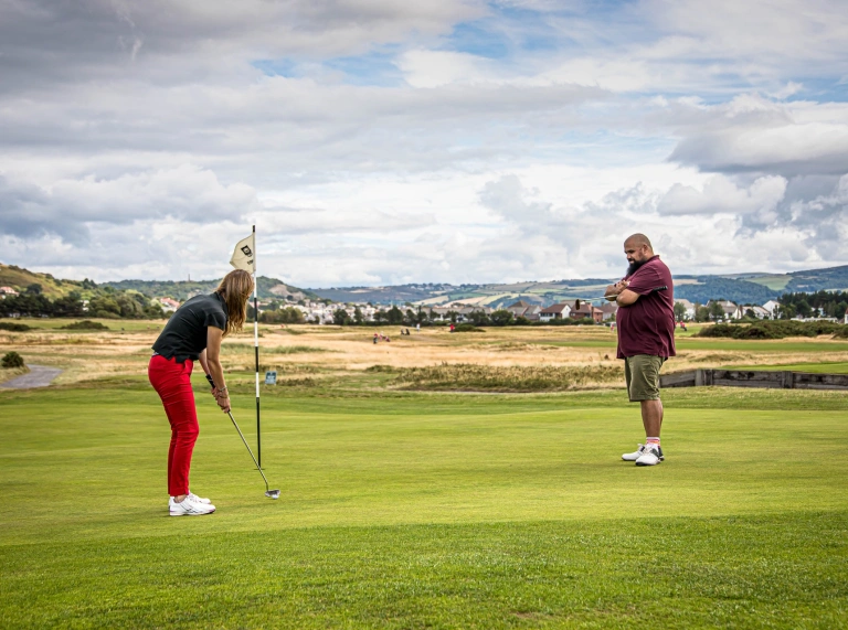 Golfers on the putting green of a championship golf course.