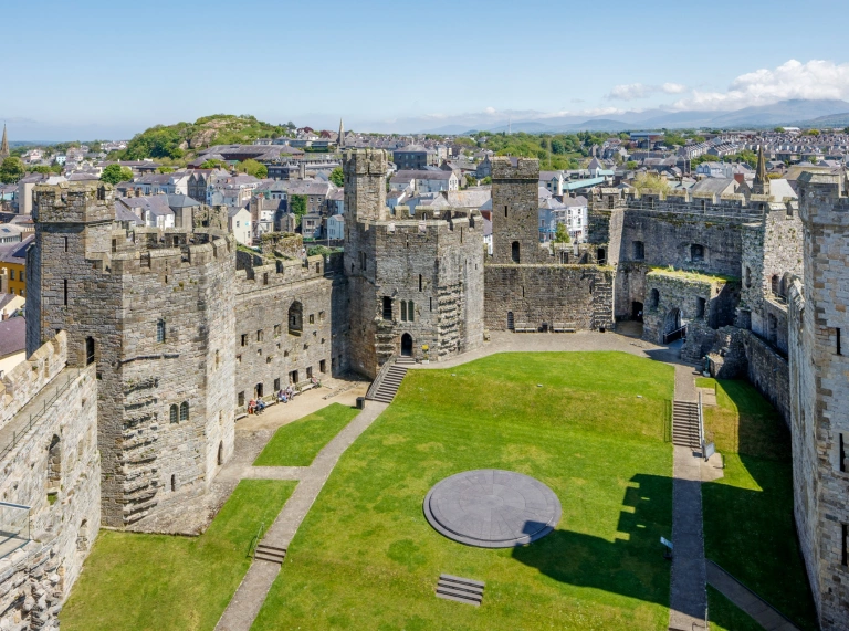 Aerial shot of a castle and the town beyond.