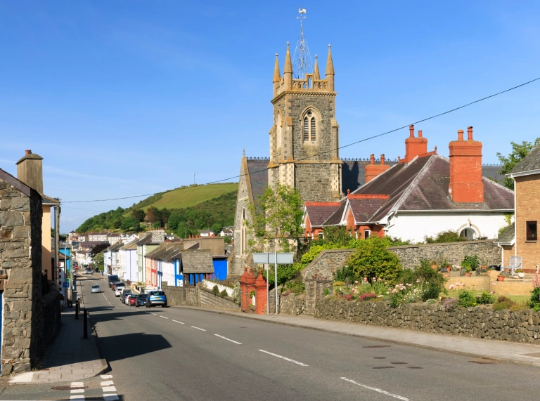 A church on a street leading toward a seaside town.