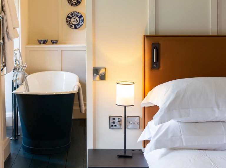 A bed and luxury bath in a hotel.