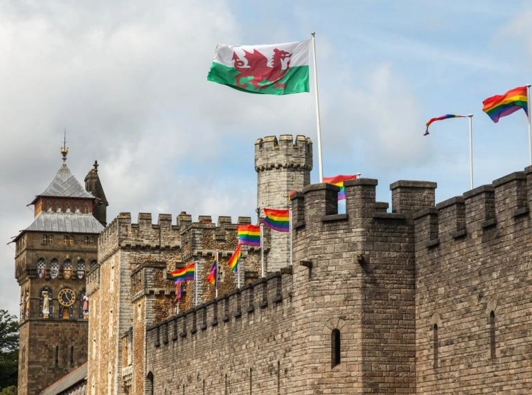 Cardiff Castle with Pride Rainbow flags and the Welsh dragon flag