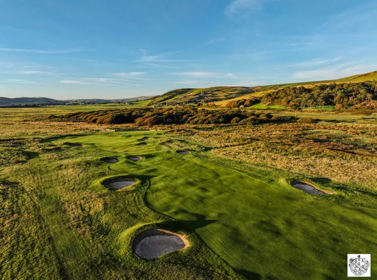 A golf course, with views of mountains beyond.
