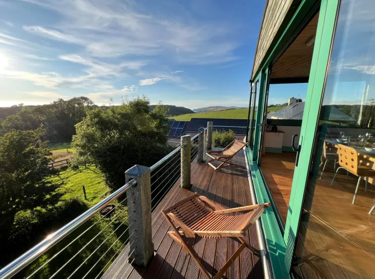 Seating on the balcony of an accommodation with countryside views.