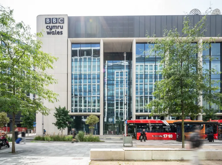 A bus outside a broadcasting house.
